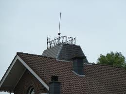 A widow's walk on top of a house by the sea