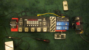 My floor rig, January 2015.  Lower left: passive direct box.  Upper row L-R: Digitech iStomp running Swing Shift, Digitech RP500, Digitech JamMan Solo with FSX3 footswitch, power strip.  Zoom H4 top right. 